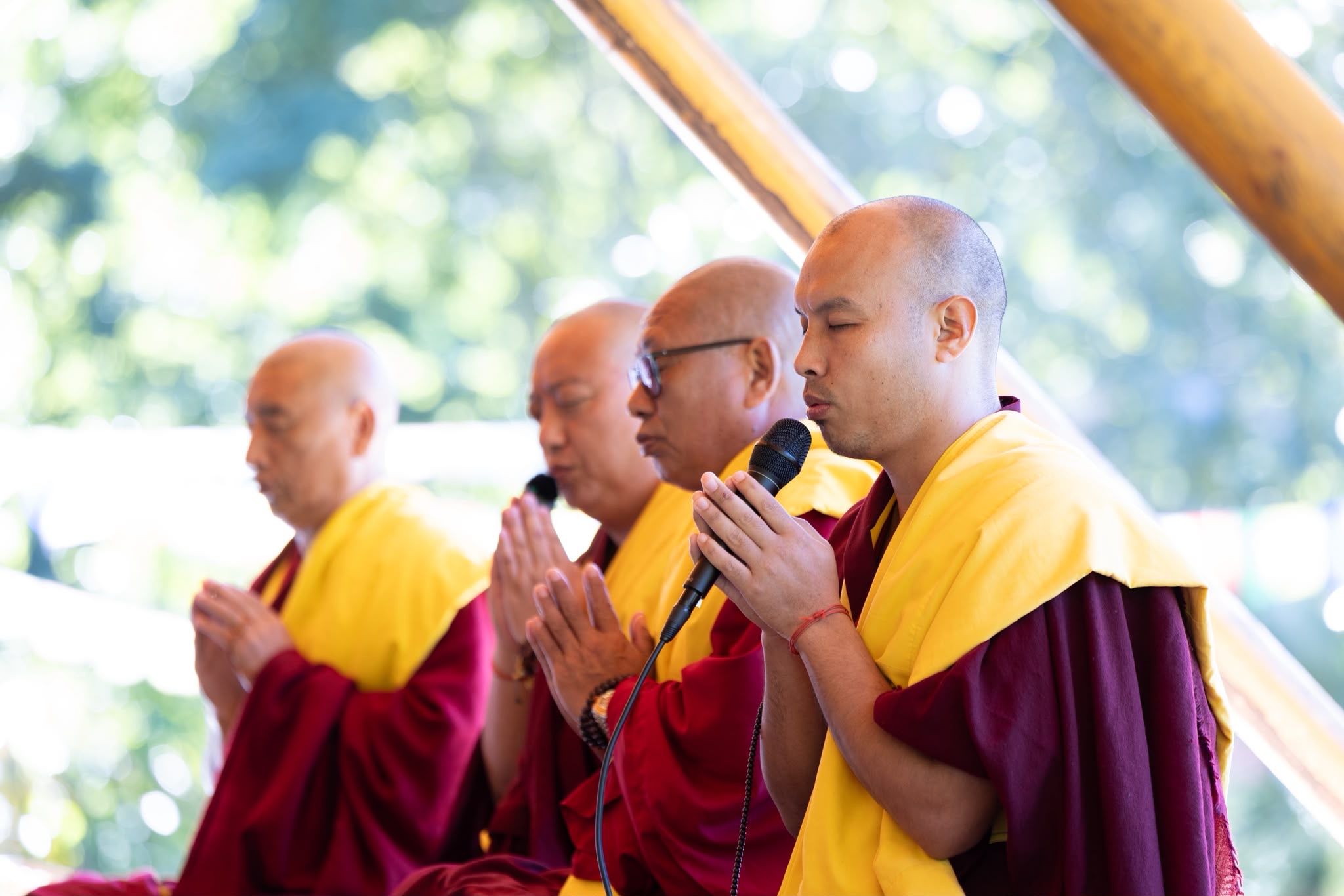 Buddhist monastics leading prayer and chanting